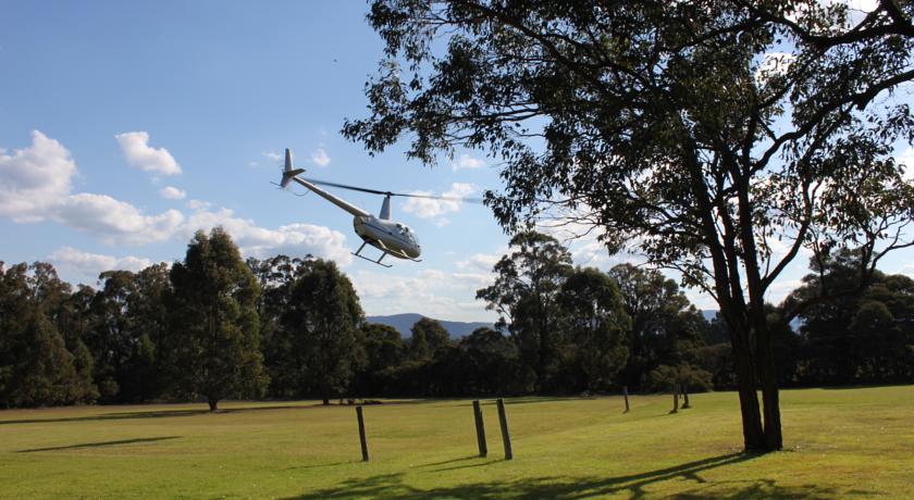 Helicopter taking off from Woodlane Cottages