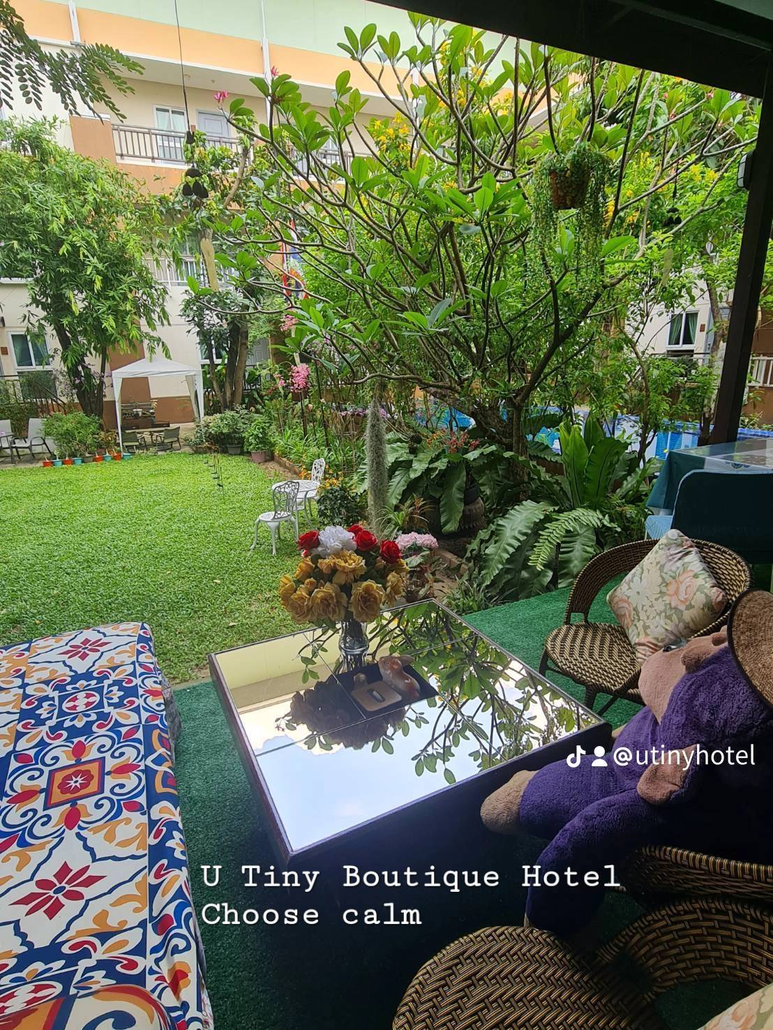 Relaxing garden seating area surrounded by nature at U Tiny Boutique Hotel