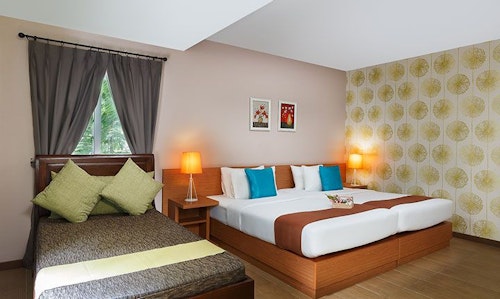 Spacious Executive Garden View room with day bed and king bed.