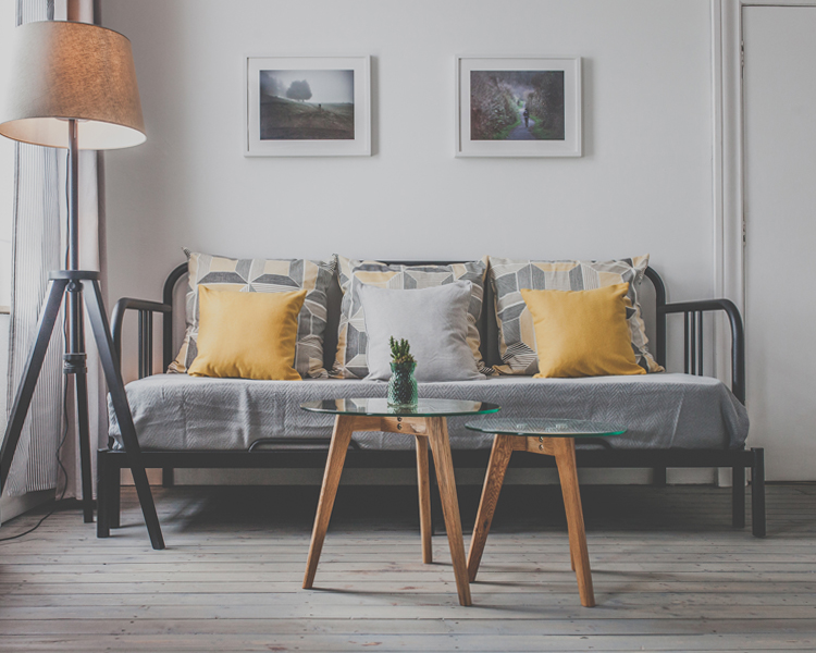 A stylish and unique decorated triple room with cozy lightning features and a sleeping couch