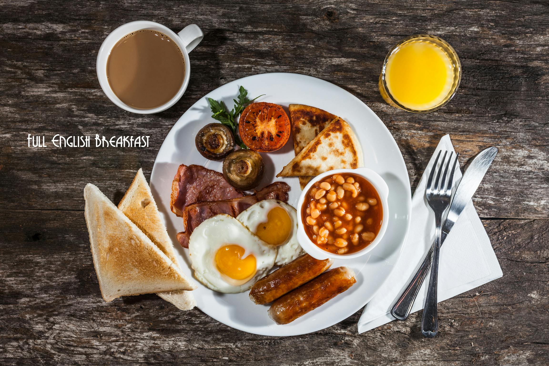 A freshly prepared full Ulster breakfast with coffee and orange juice