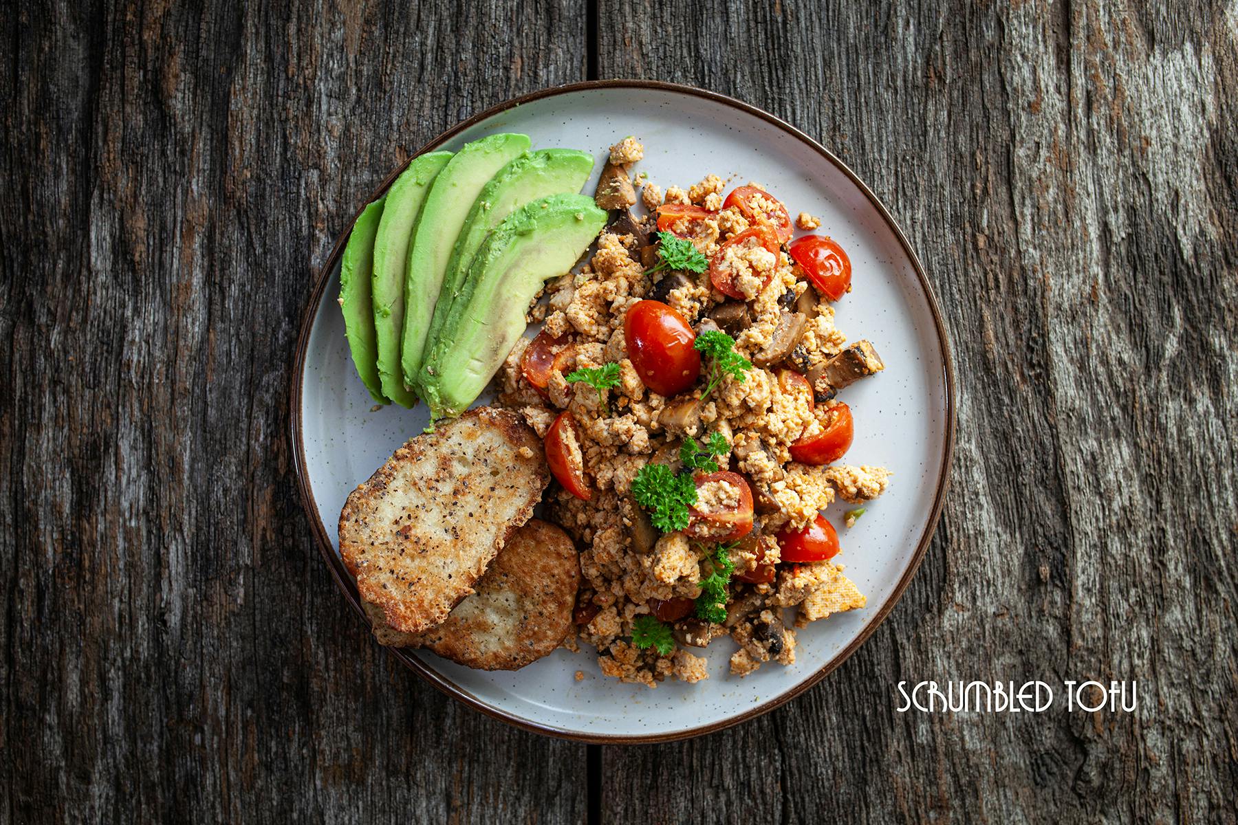 scrumbled tofu with mushrooms, tomato, avocado and fried toast
