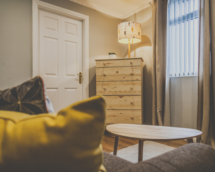 A beautifully decorated sitting area in a cozy atmosphere with table, couch and furniture