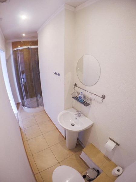 Ensuite bathroom with shower, sink and toilet. Towels and toiletries provided