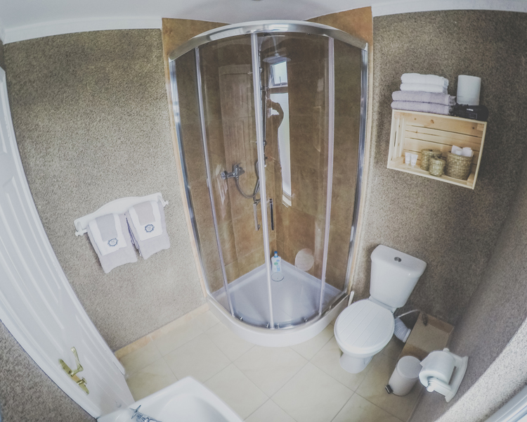 Ensuite bathroom with shower, sink and toilet. Towels and toiletries provided