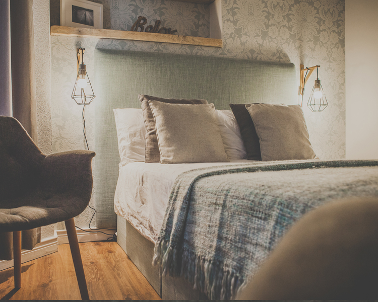 Pillows are on the bed of a beautifully decorated double room with ensuite in a cozy atmosphere