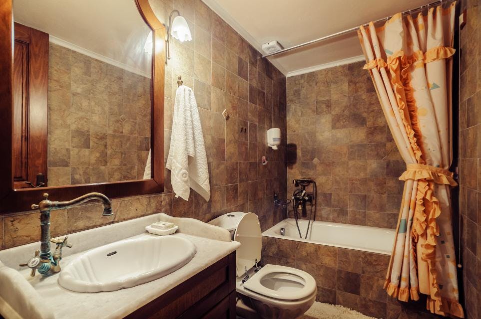 Μπάνιο Σουίτας 1ου ορόφου με μπανιέρα και ντους Superior Suite's bathroom with shower above bath