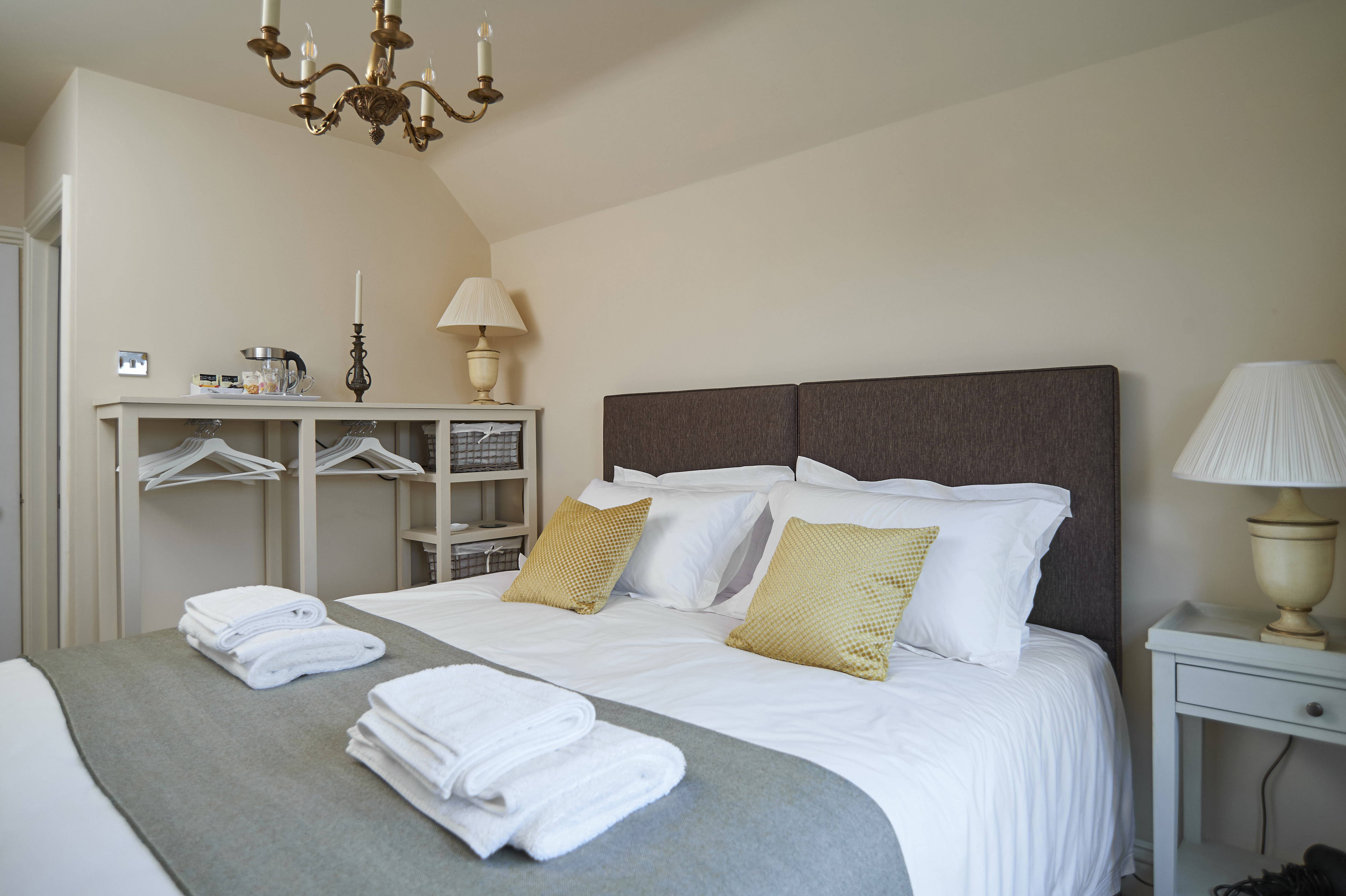 Twin Room as Superking bed with view of open wardrobe and tea/coffee tray.