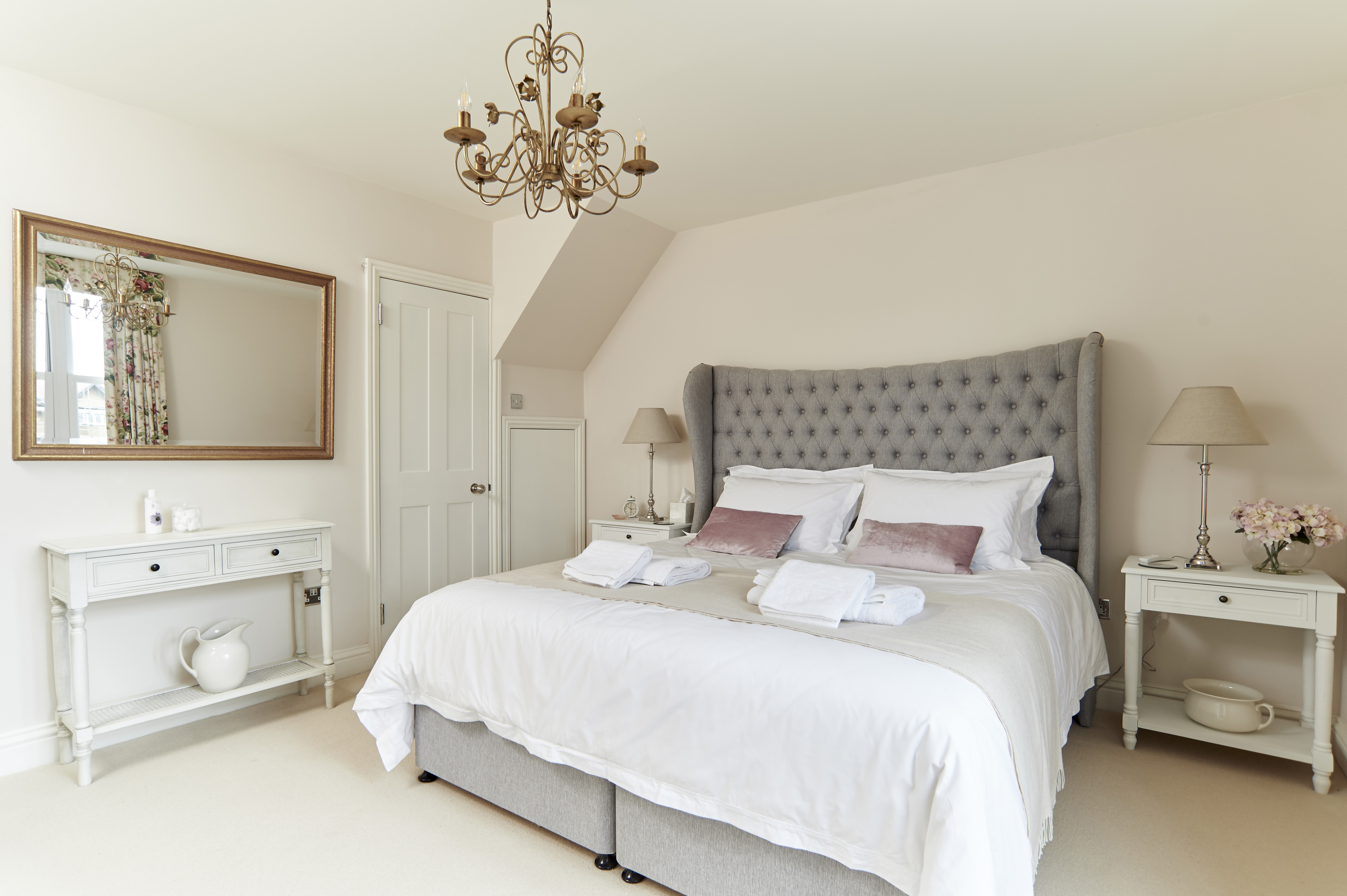 View of Master bedroom Hypnos Bed with beautiful, decorative headboard, crisp white bed linen and throw.