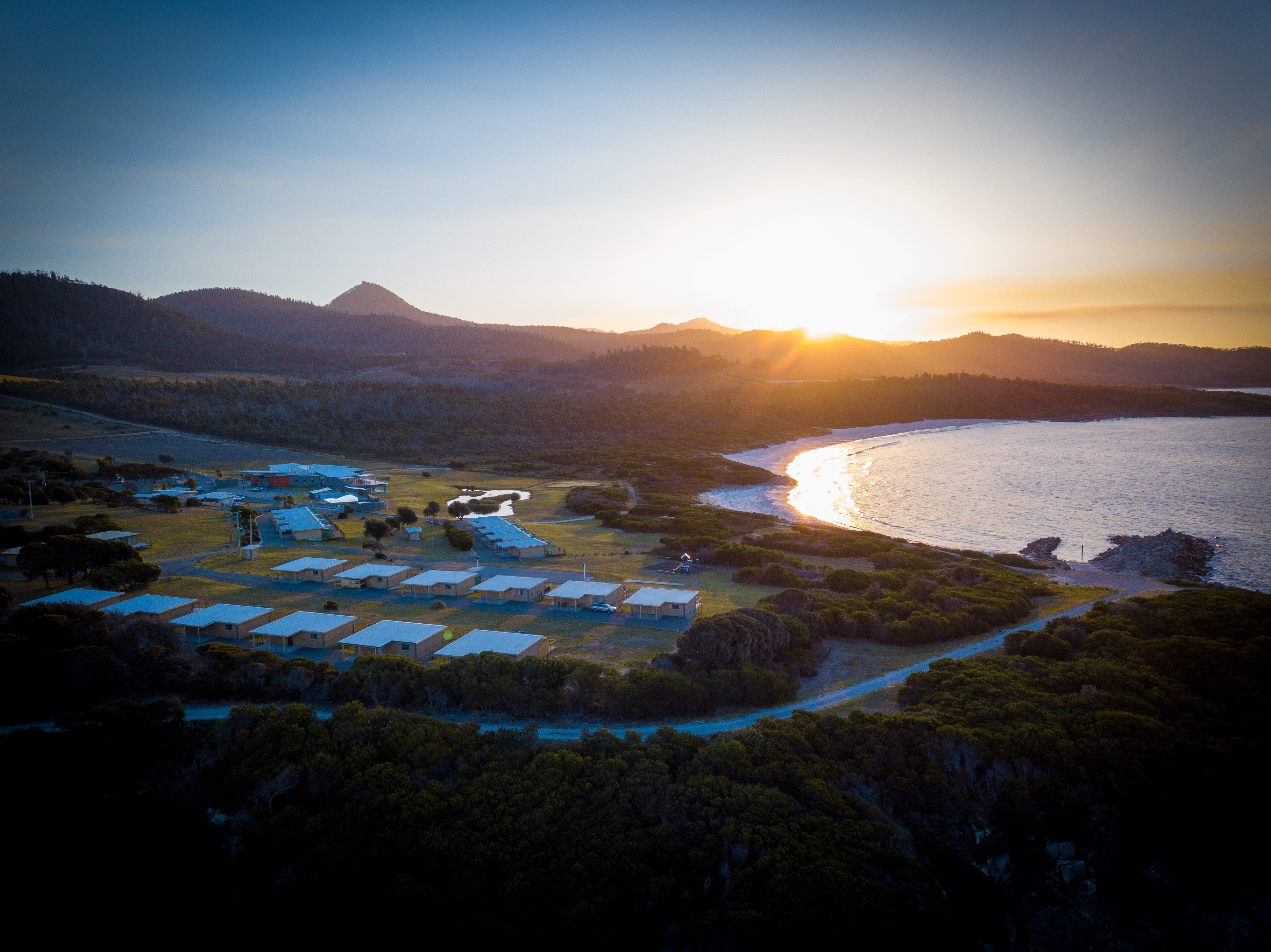 White Sands Estate from above with ocean and mountain views at dusk