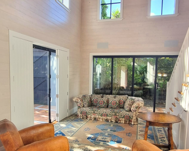 Sunny downstair living area with leather armchairs and couch - The Barn, 970 Lonely Bay Lodge