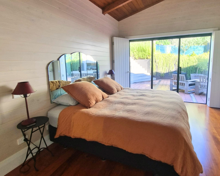 Downstairs bedroom with private outdoor seating area - The Barn, 970 Lonely Bay Lodge