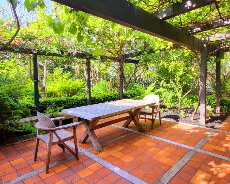 Outdoor dining area on cobblestone patio - The Barn, 970 Lonely Bay Lodge