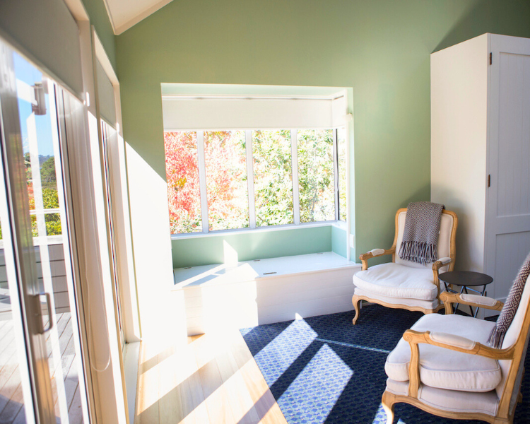 Indoor seating in front of bi-fold doors - Purangi Suite, 970 Lonely Bay Lodge