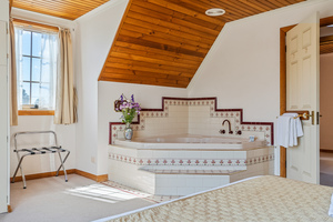 Bayview attic spa master bedroom with 2 person corner spa.