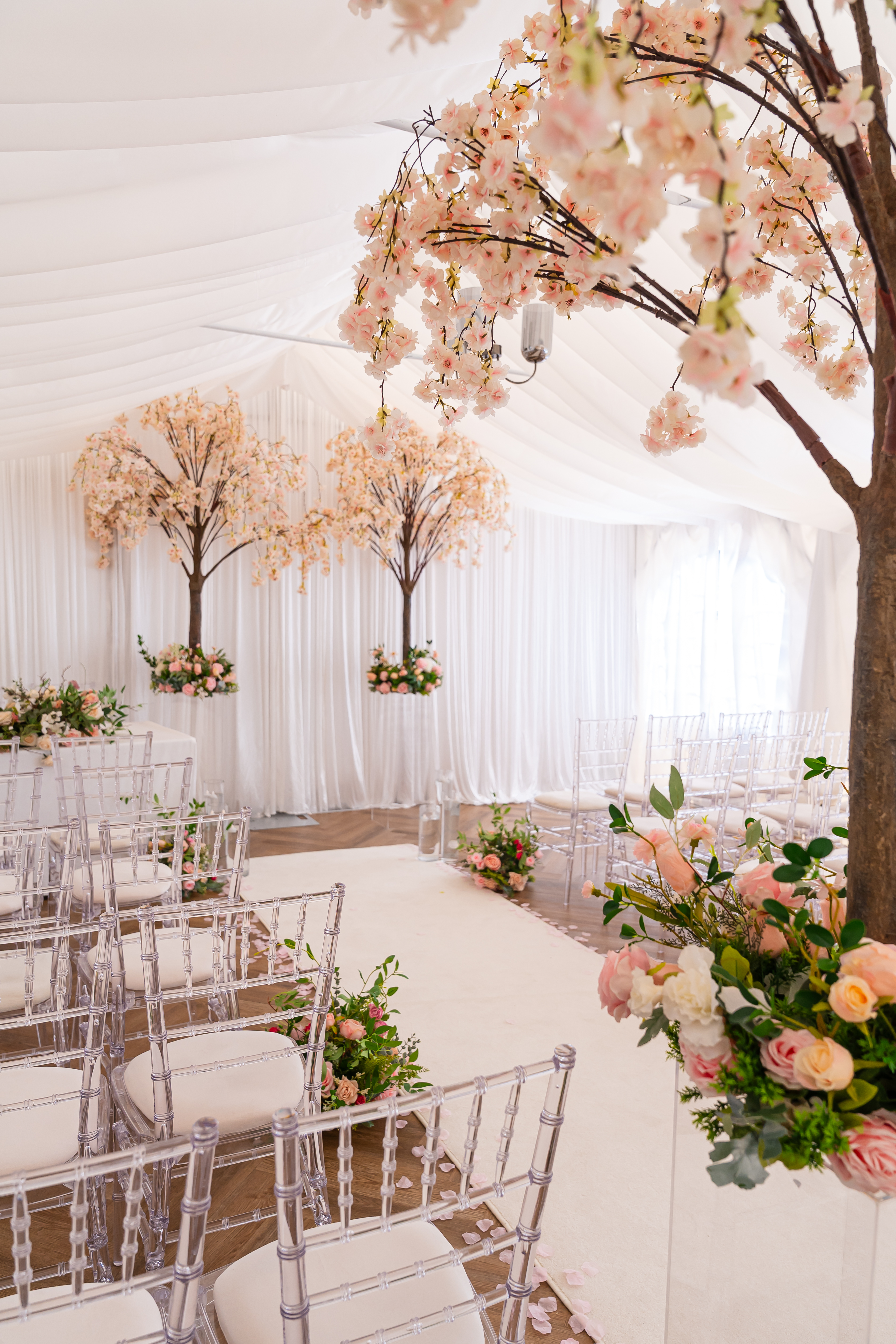 Elegant Wedding ceremony setup with flowers and white chairs