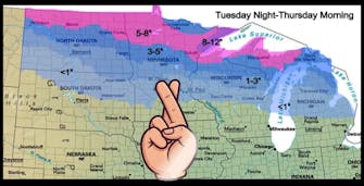 Fingers crossed sign over weather map.