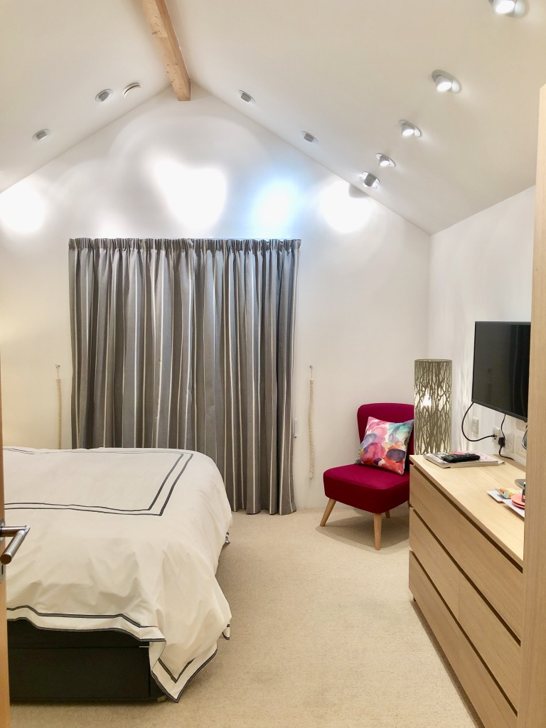 Bedroom 2 with view of vaulted ceiling and down lights