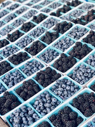 Blueberries and blackberries in blue boxes