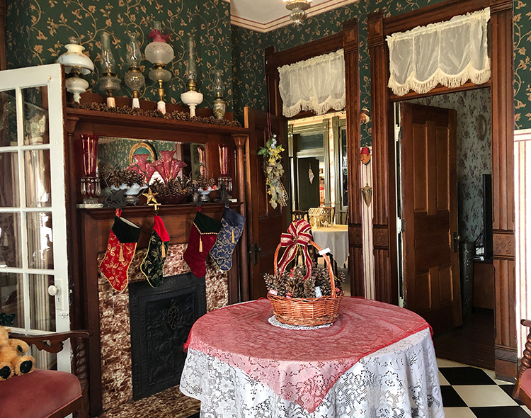 Red holiday decor & stockings hung on the fireplace. The Foyer at The Victorian on Main