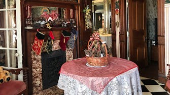 Red holiday decor & stockings hung on the fireplace. The Foyer at The Victorian on Main