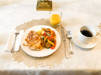 Plated breakfast with french toast, roasted veggie scramble, juice and coffee at The Victorian on Main, Fairfield, Il