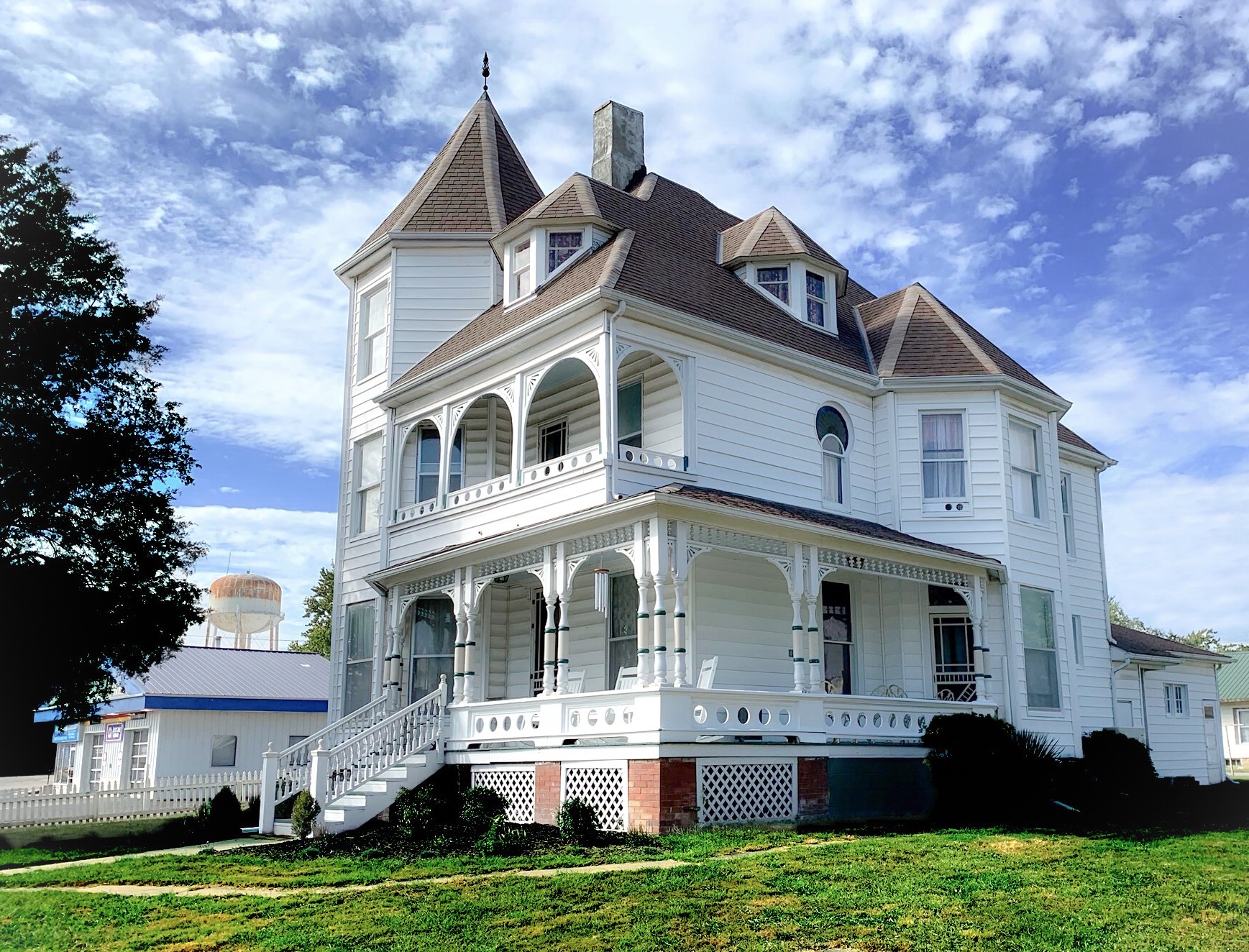 The Victorian on Main bed & breakfast, Fairfield, Il. White, 3-story Queen Anne Victorian architecture.