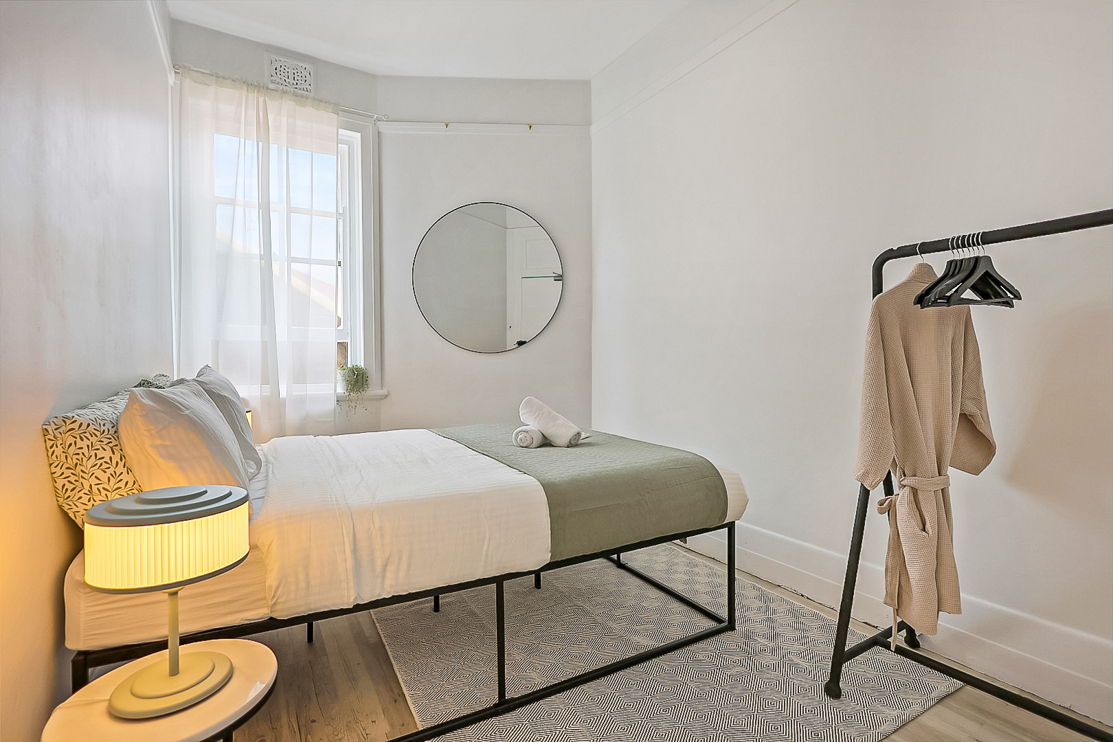 Cosy private double room with large mirror, clothes rail, complimentary toiletries and towels.