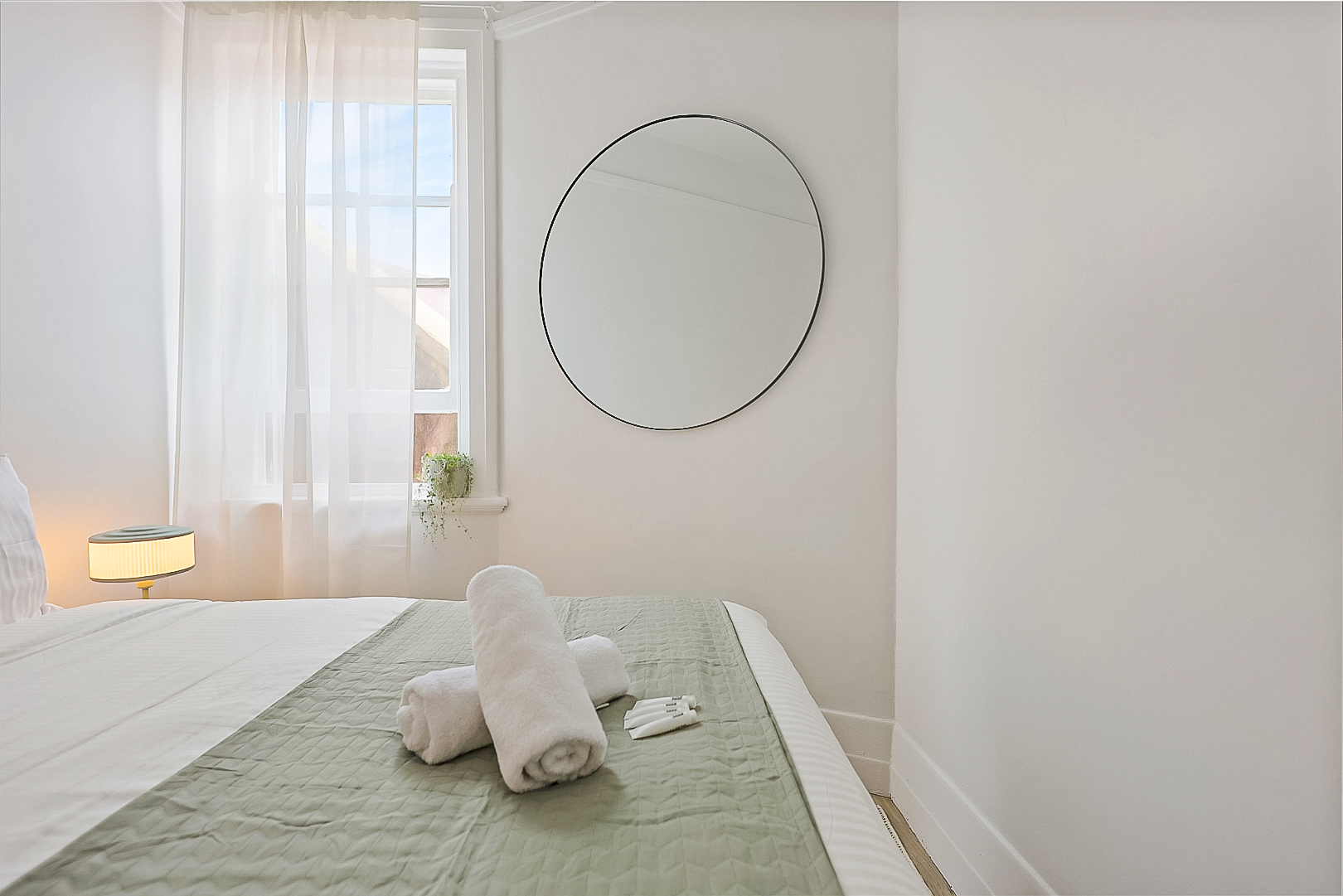 Cosy private double room with large mirror with complimentary toiletries and towels.