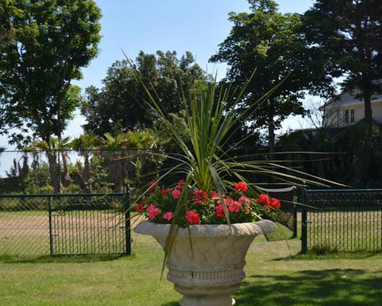 Haven Hall Hotel. View of urn with Tennis Court behind