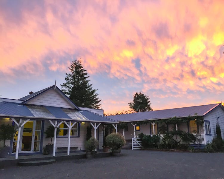 Pink sunset and main entrance at Tongariro Crossing Lodge