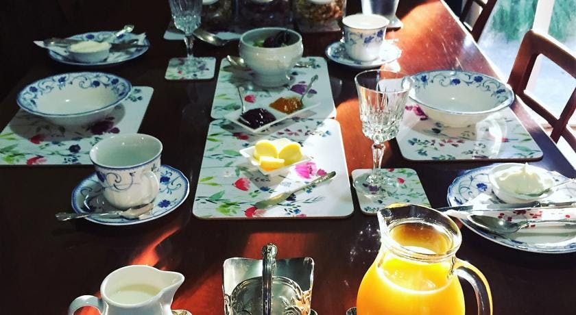 Continental breakfast table set with silverware,china, orange juice, jam, fruit, butter at Tongariro Crossing Lodge