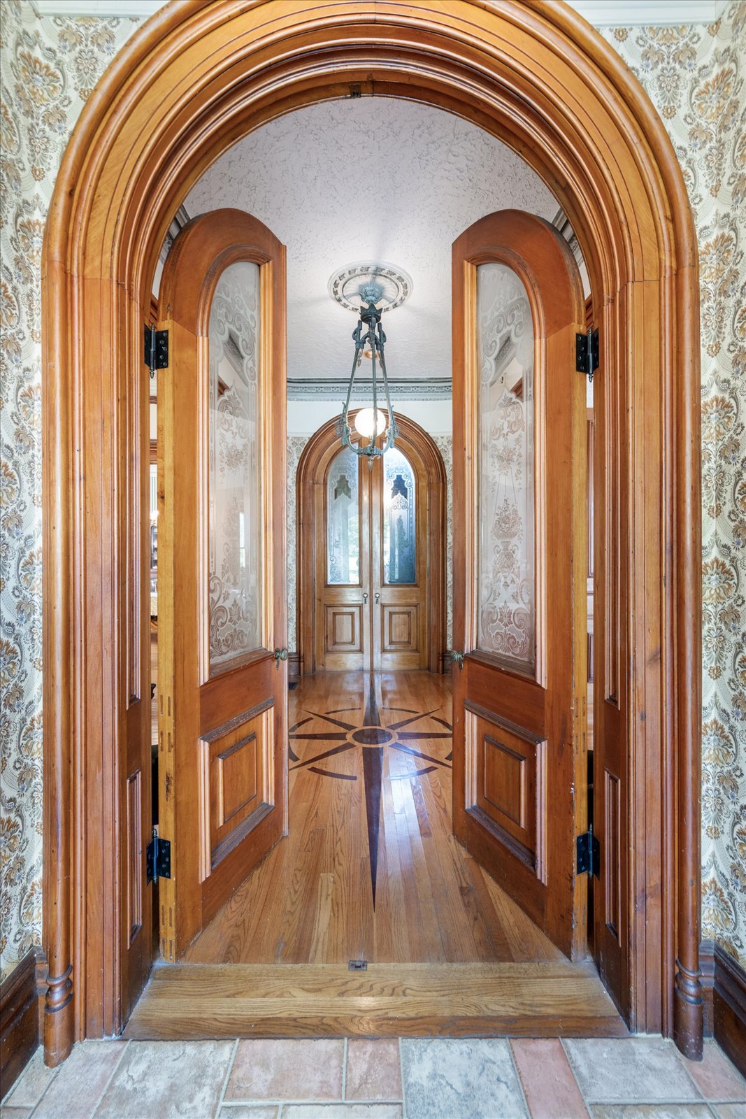 Front entry way with ornate wood flooring at Limestone Mansion