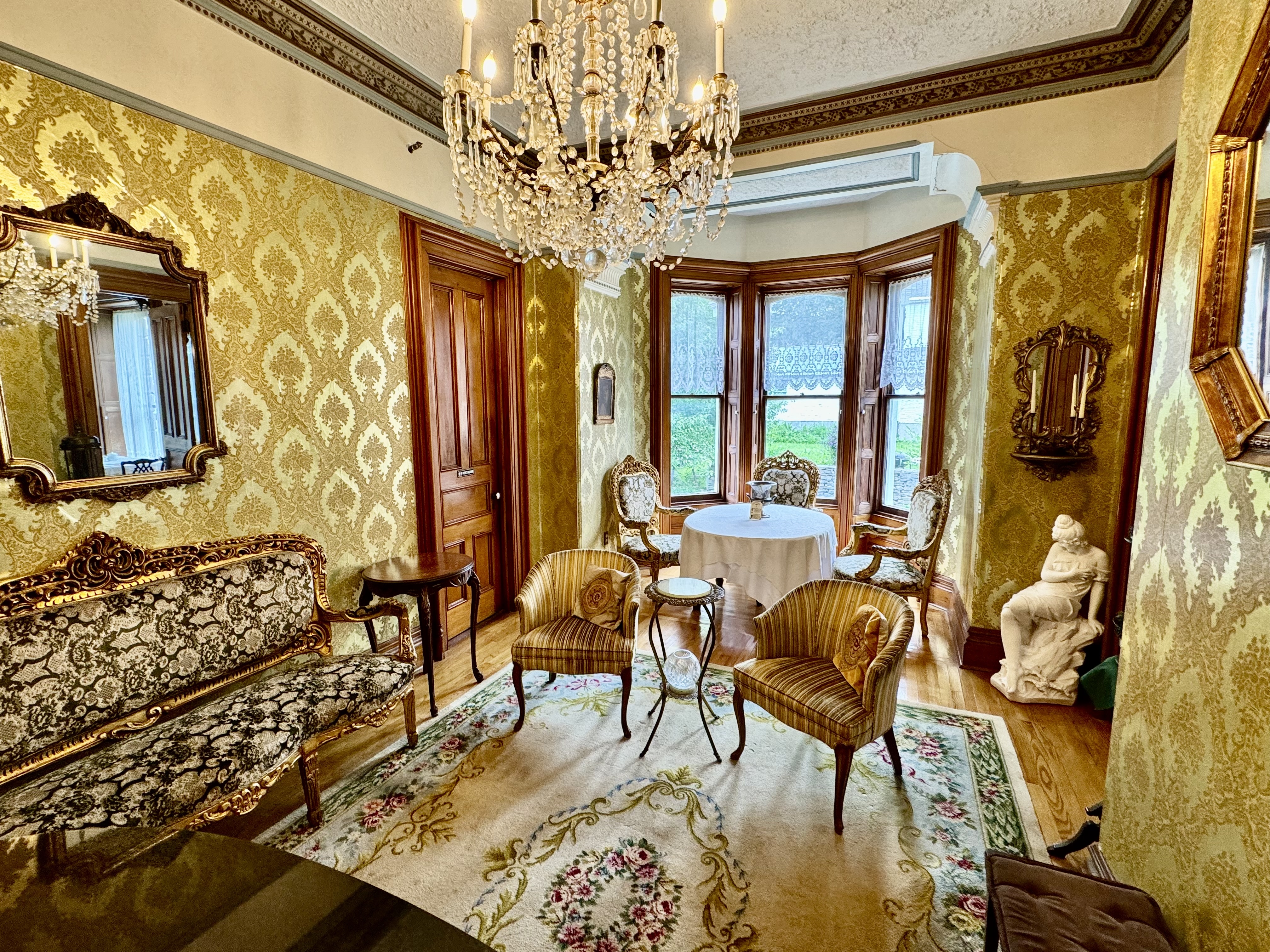 Victorian parlor at the Limestone Mansion Bed and Breakfast with period furnishings