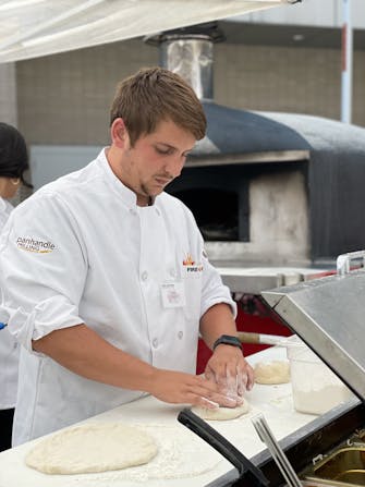 General Manager making pizza