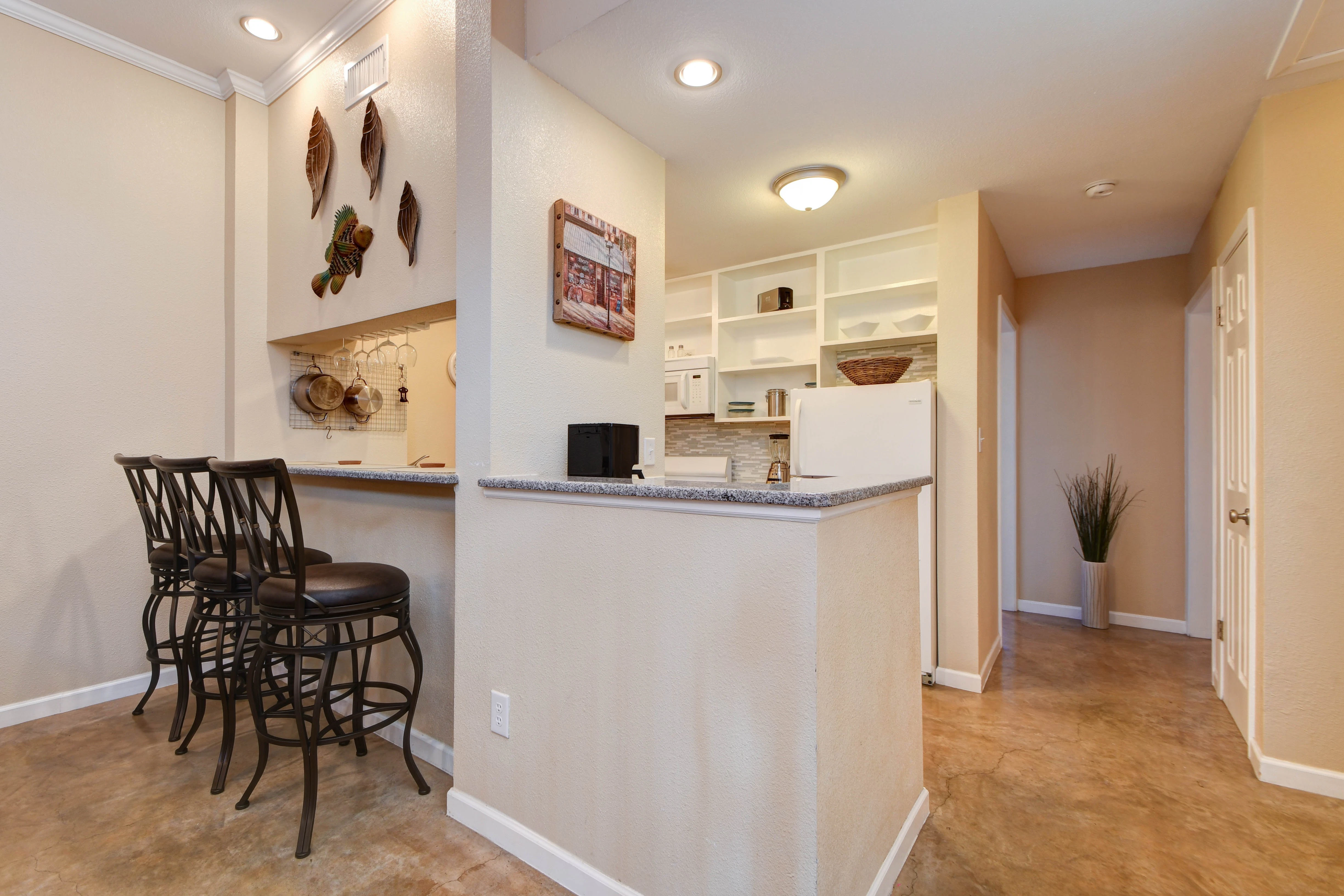 A wide view of a suite's kitchenette and dining area