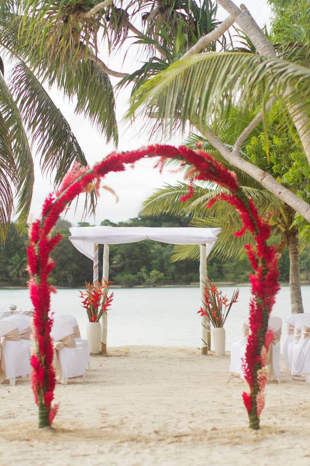 Wedding Ceremony on Coconut Beach Floral Arch with Bamboo Canopy #erakorbeachweddings #weddingceremonyonthebeachsouthpacific