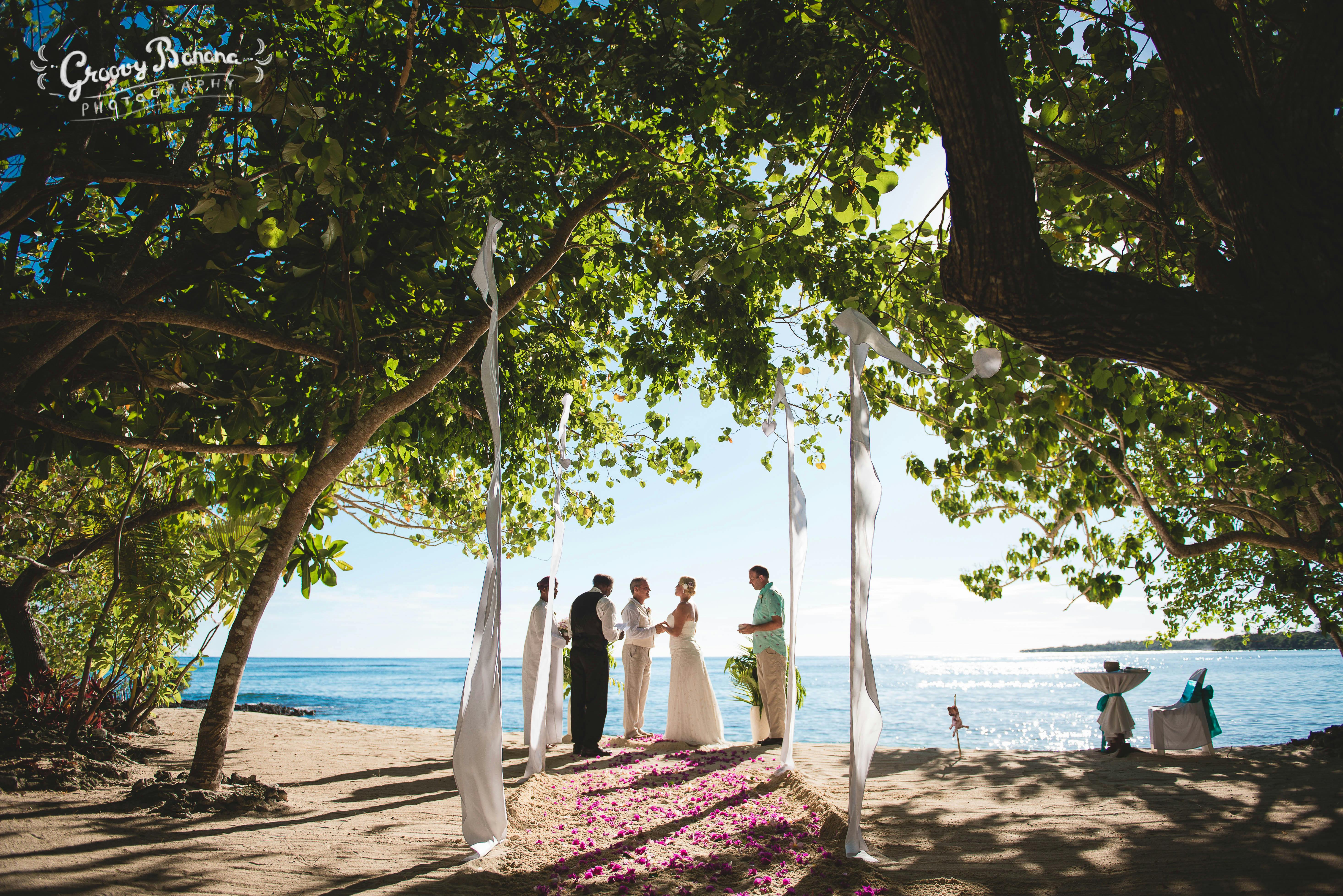 Sunset Beach, scattered floral aisle and Bali Flags #erakorbeachweddings #weddingceremonyonthebeachsouthpacific