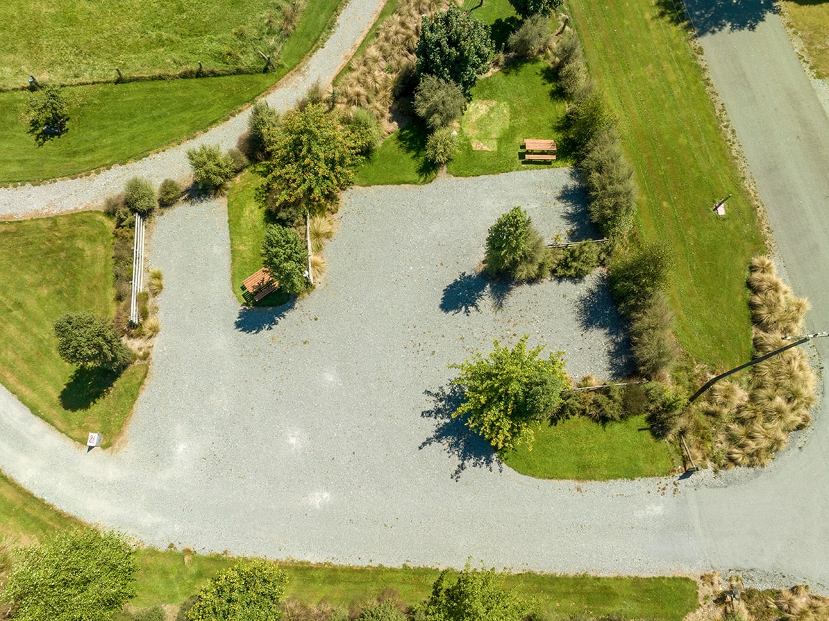 Large campervan parking area with trees and shrubs at Musterer's Accommodation, Fairlie.
