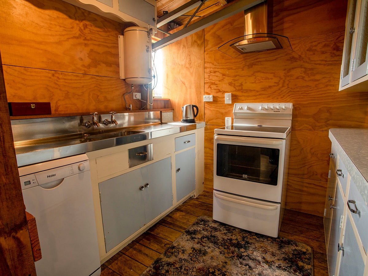 A rustic kitchen with full oven at Musterer's Accommodation, Fairlie.