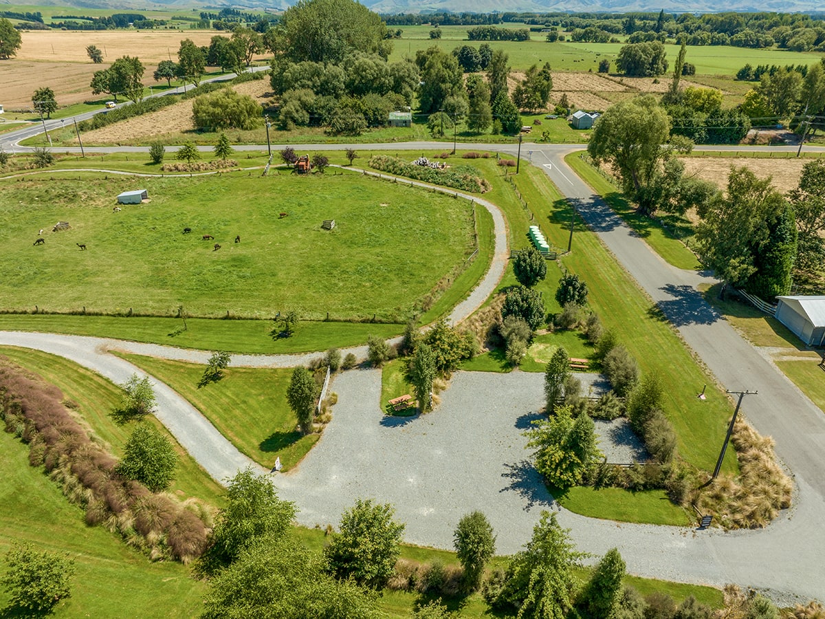 A large parking area with green landscaping at Musterer's Accommodation, Fairlie.