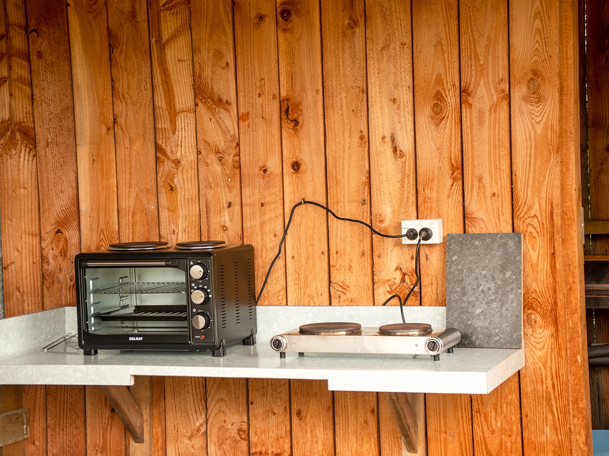 A kitchenette bench in a rustic cabin at Musterer's Accommodation, Fairlie.