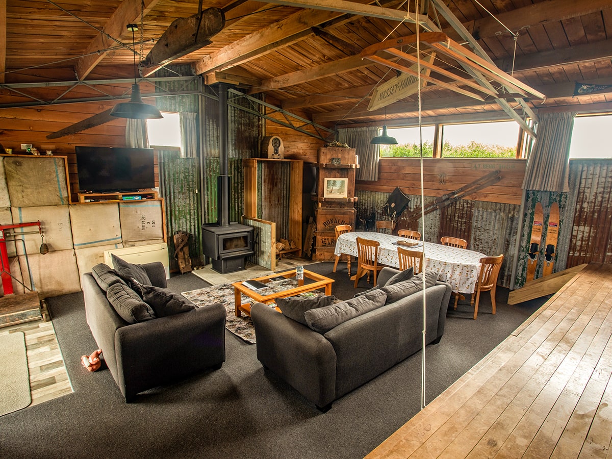 A large rustic living area in an old woolshed at Musterer's Accommodation, Fairlie.