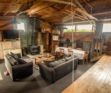 A large rustic living area in an old woolshed at Musterer's Accommodation, Fairlie.