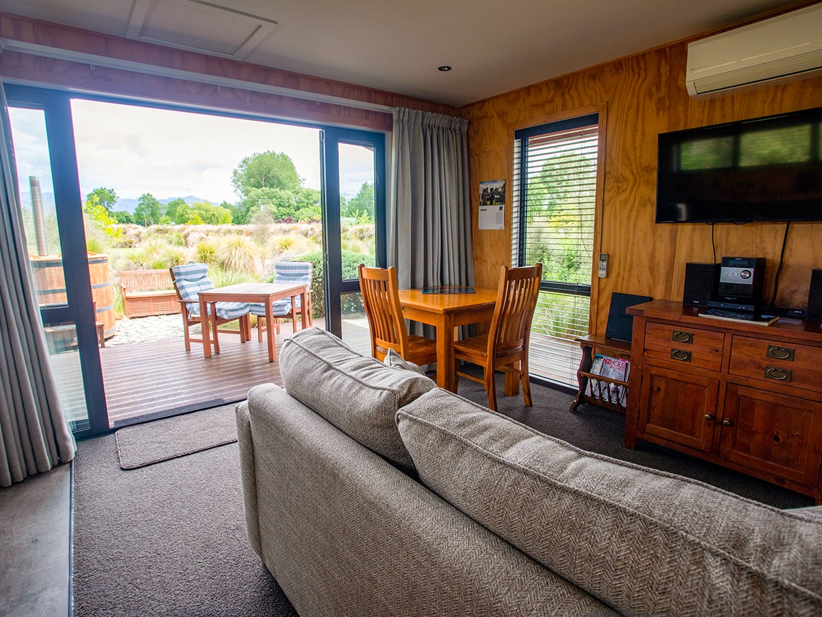 A modern-rustic living area and outdoor eating area at Musterer's Accommodation, Fairlie.