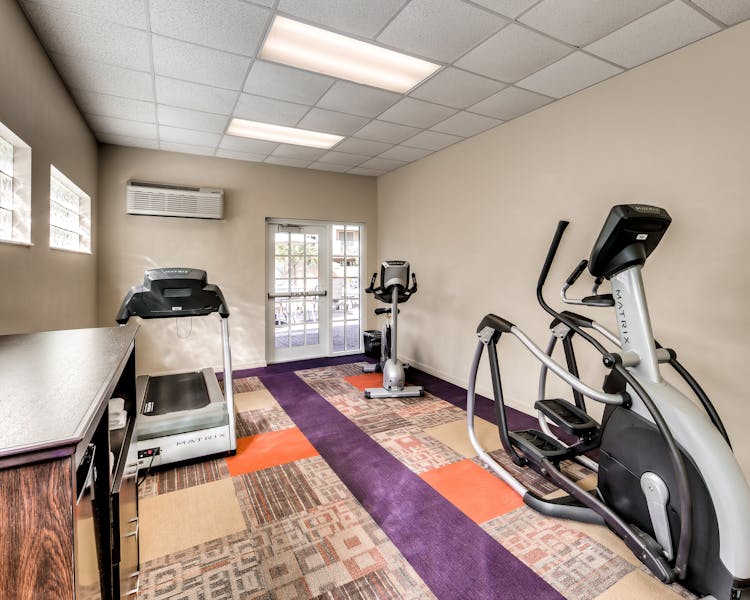 Fitness room with treadmill, elliptical, and exercise bike