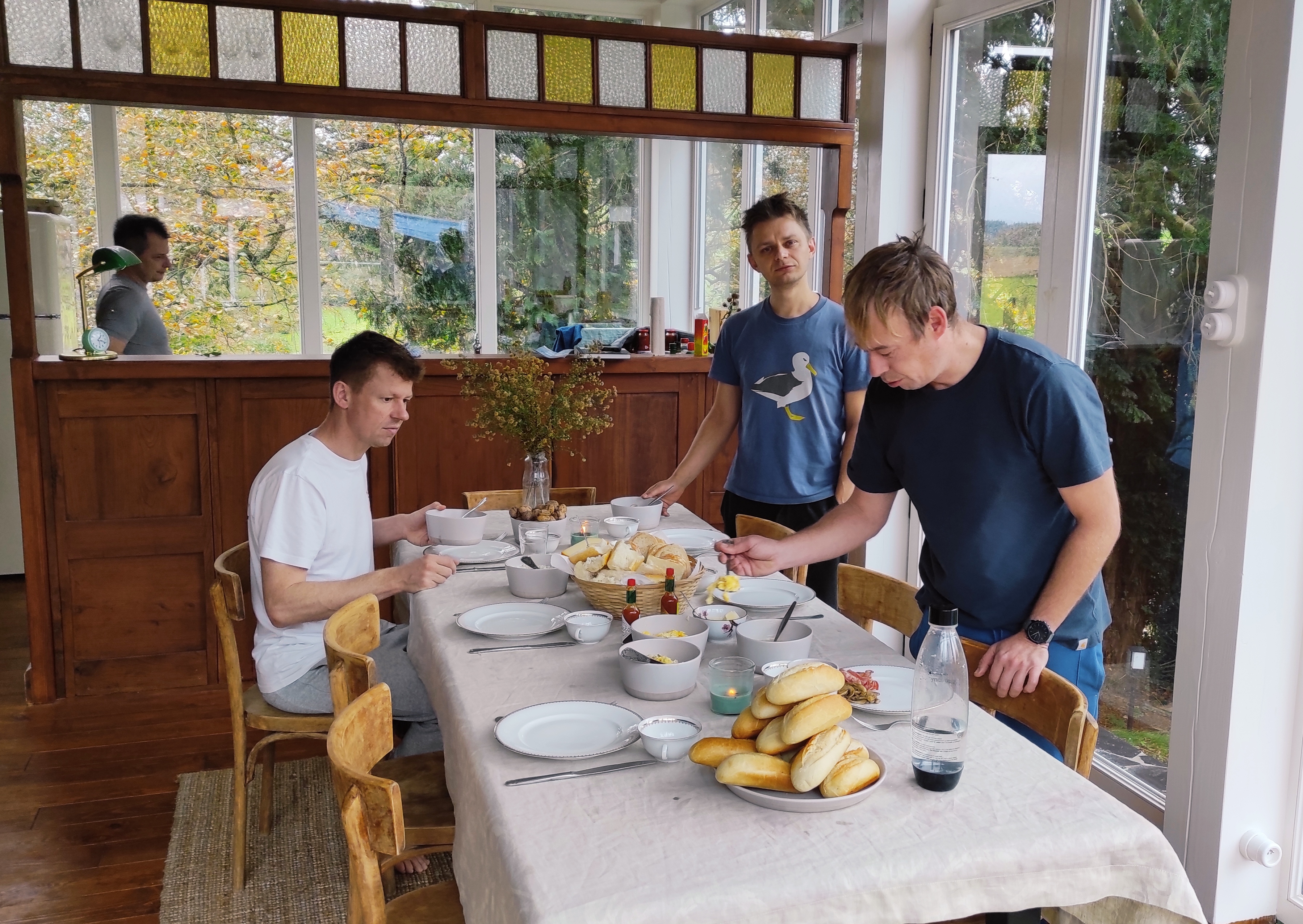 Breakfast and dinners at the communal table at La Maison Vienvenue, a social space for sharing stories among cyclists, hikers