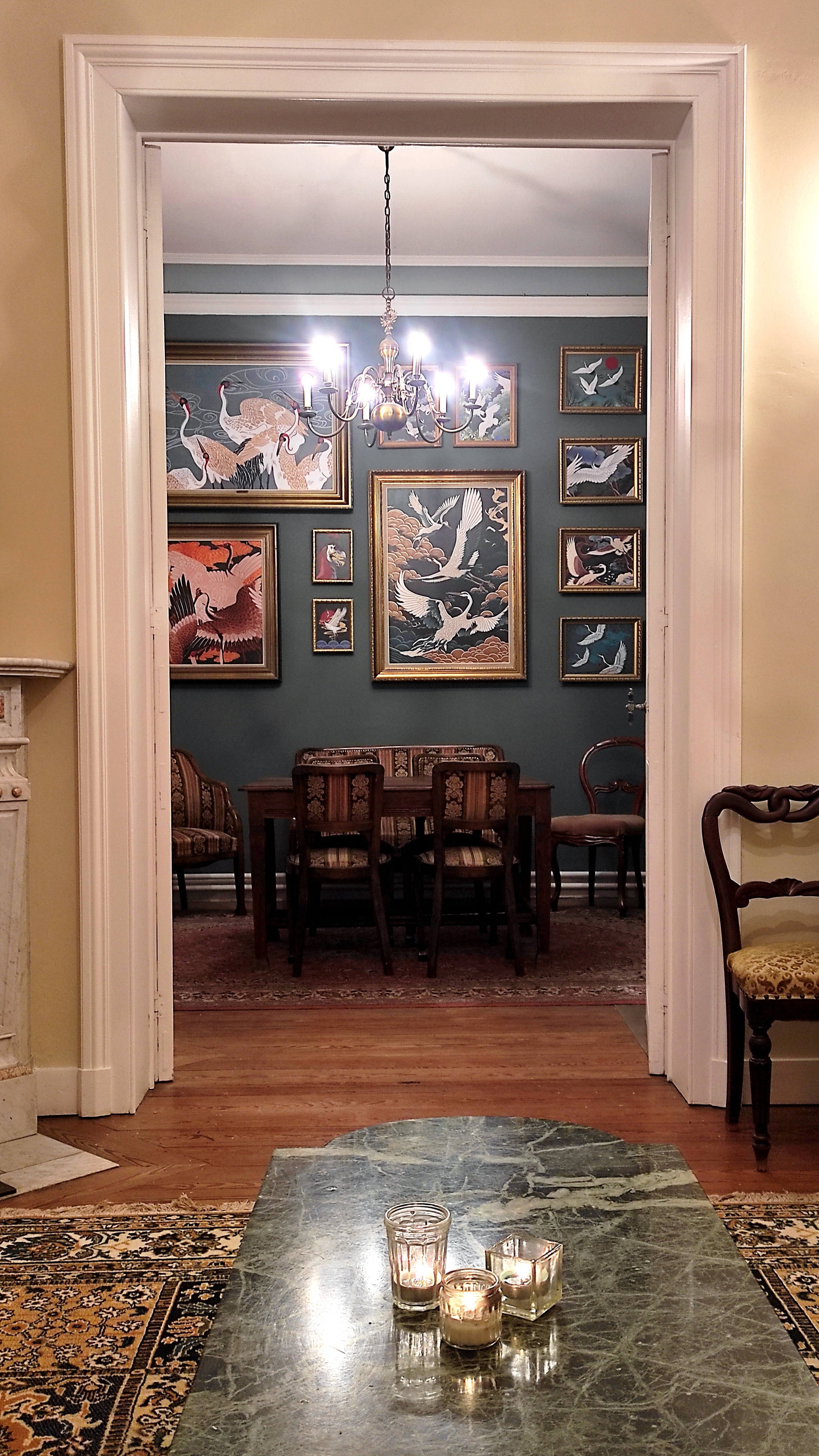 Authentic salon at La Maison Vienvenue with crane bird paintings, ideal for board games after a day of cycling or hiking.