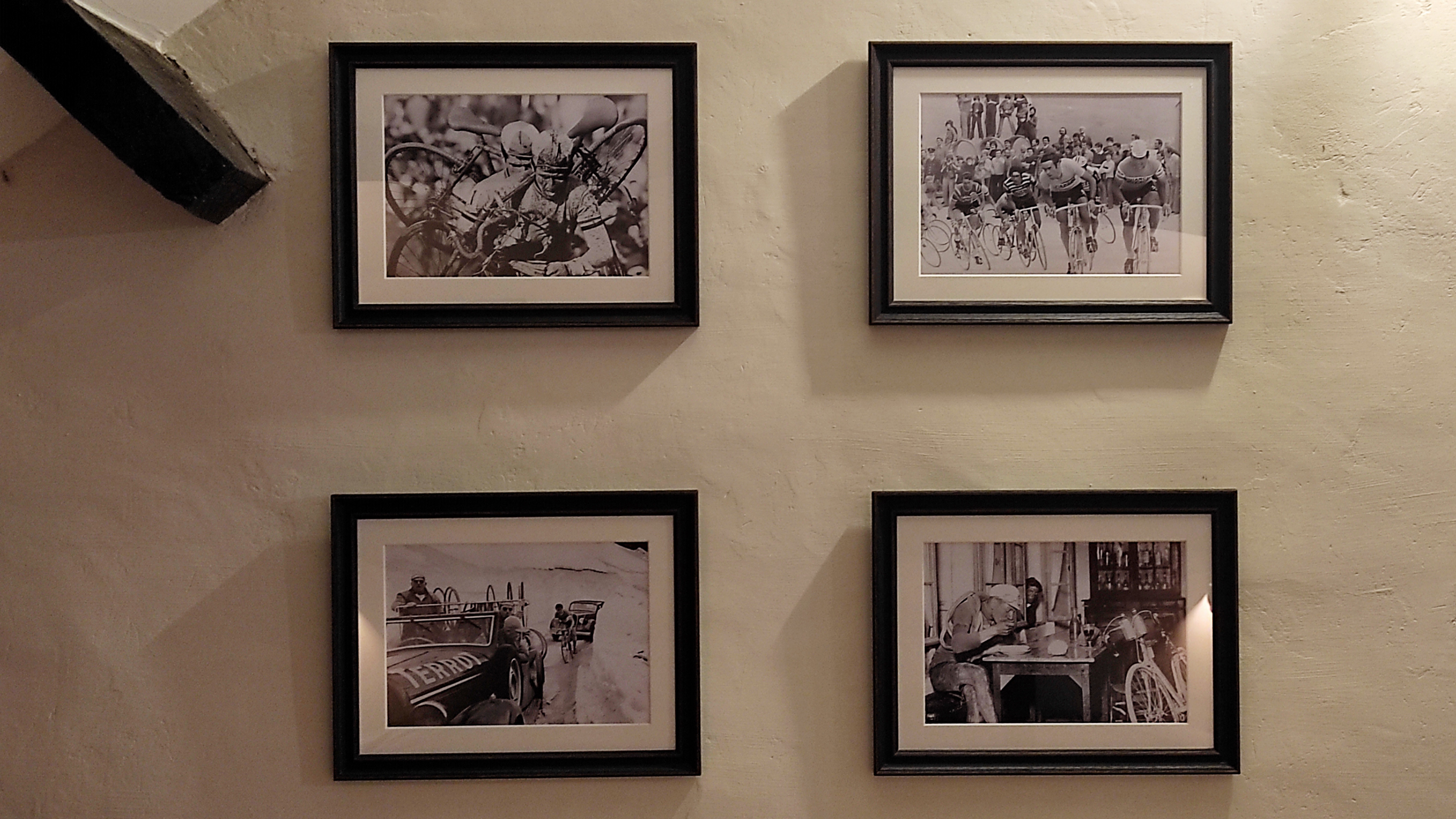 Close-up of retro pictures of race cyclists as decoration in a hostel-style room for cyclists at La Maison Vienvenue.