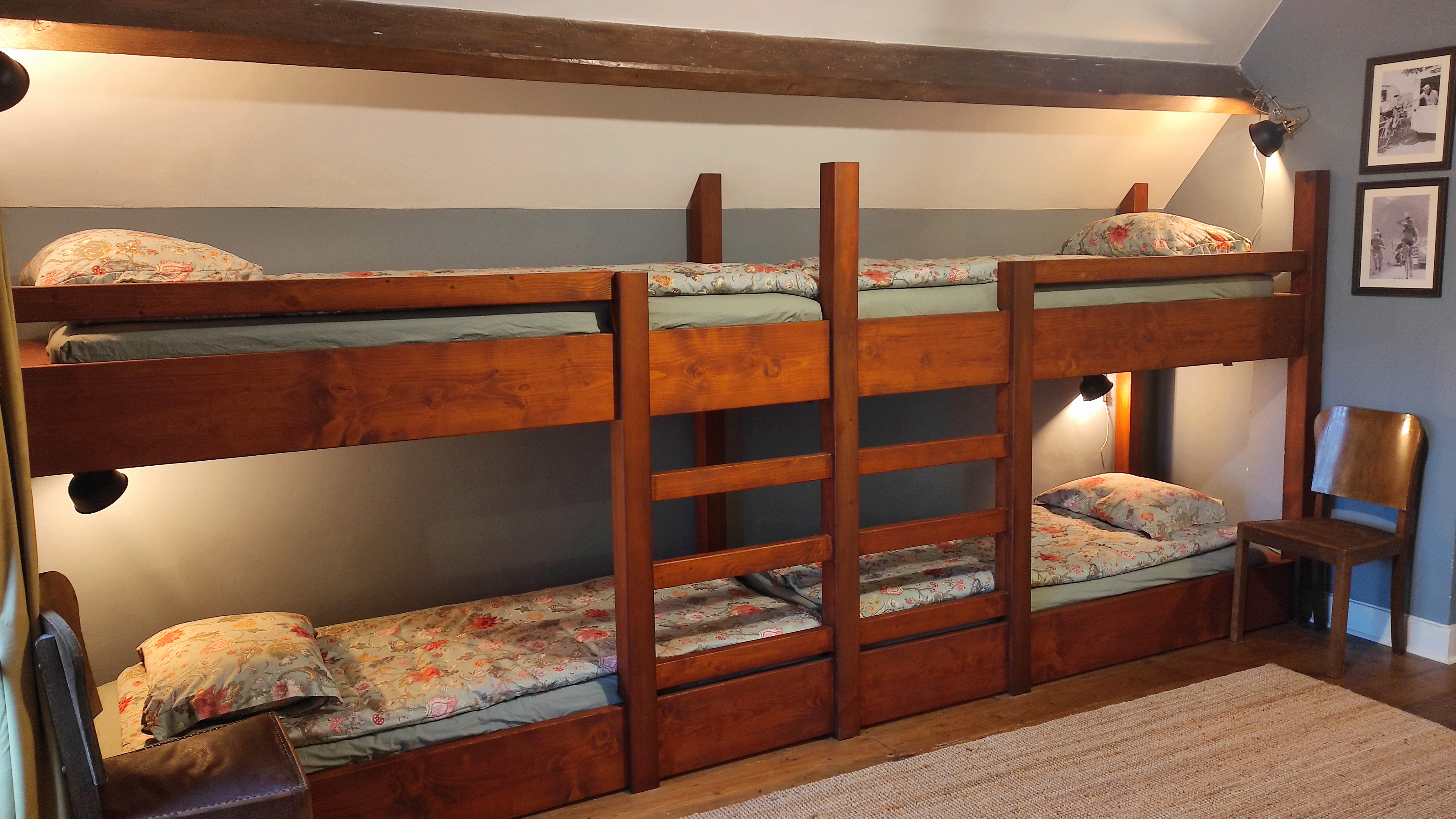 Spacious hostel-style room for eight people at La Maison Vienvenue, featuring individual beds with own lights and sockets